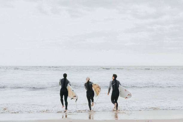 istock Happy friends surfing at the beach 2158212617