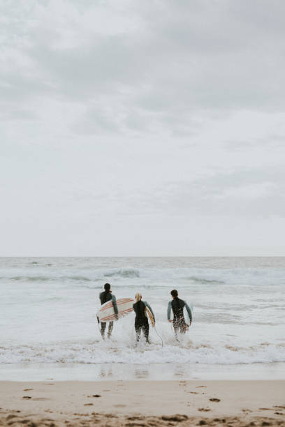 istock Happy friends surfing at the beach 2158212618