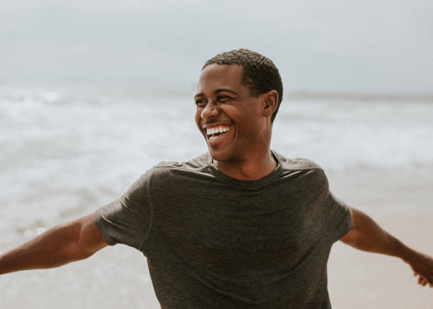 istock Cheerful man enjoying on the beach 2158212635