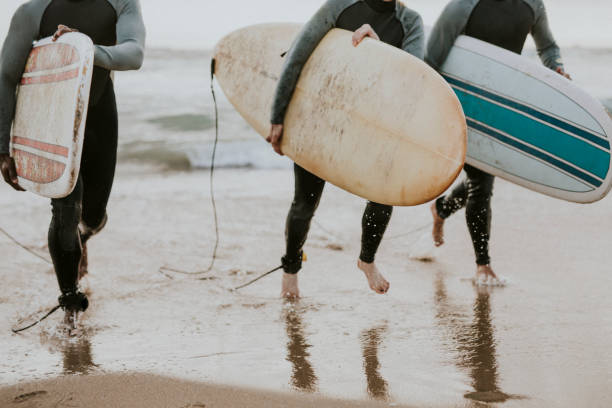 istock Happy friends surfing at the beach 2158212641