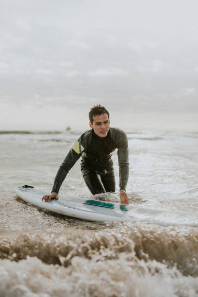 istock Man surfing at the beach 2158212676