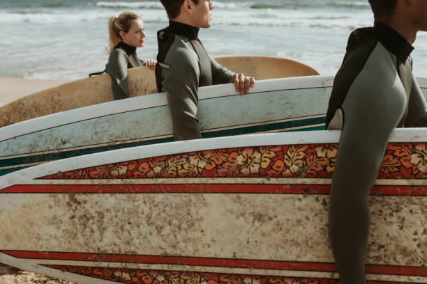 istock Surfers at the beach on a sunny day 2158212886