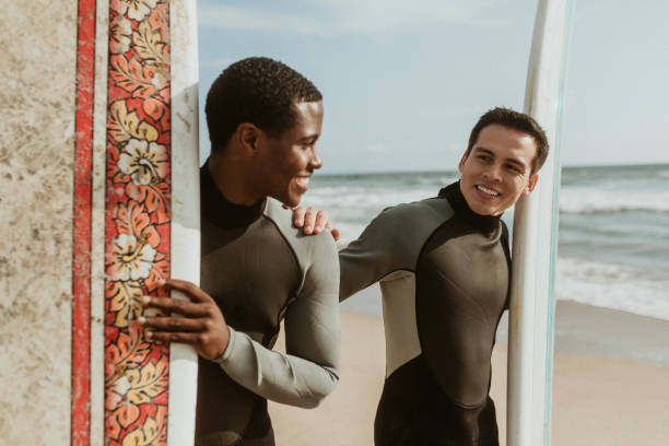 istock Happy surfers at the beach 2158212968