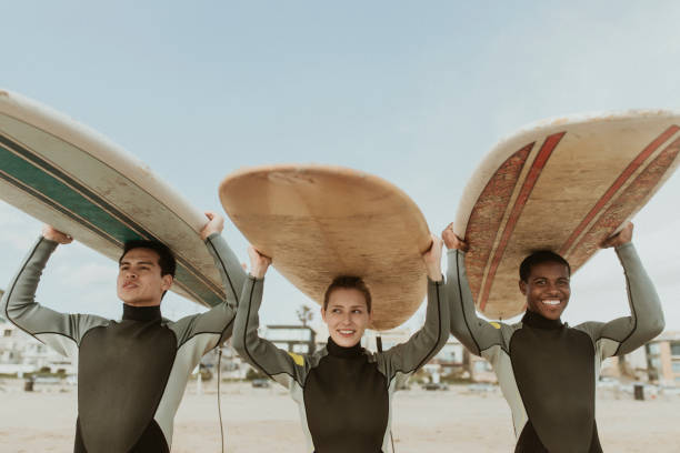istock Happy friends surfing at the beach 2158213047