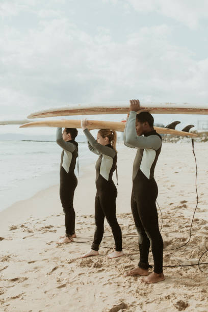 istock Happy friends surfing at the beach 2158213068