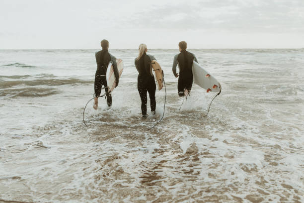 istock Surfers running towards the sea 2158213069