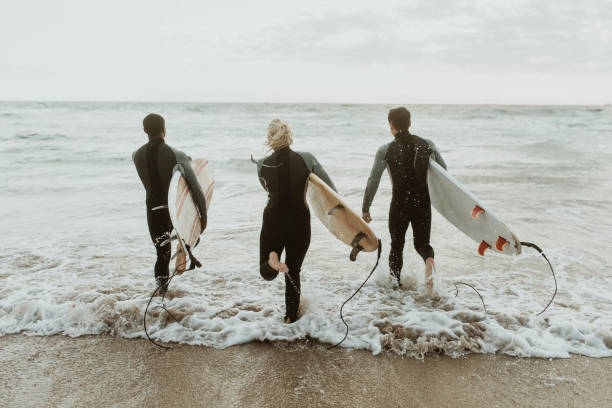 istock Surfers running towards the sea 2158213079