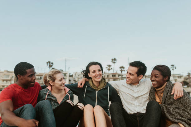 istock Cheerful friends hugging on the beach 2158213142
