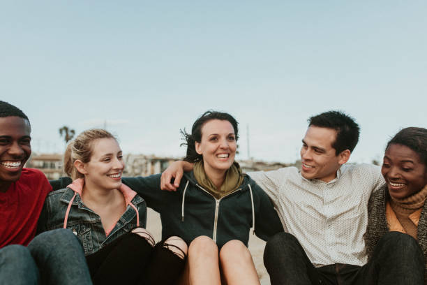 istock Cheerful friends hugging on the beach 2158213650
