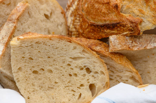 istock Homemade sourdough bread sliced ​​in a bread plate, close-up view 2158213656