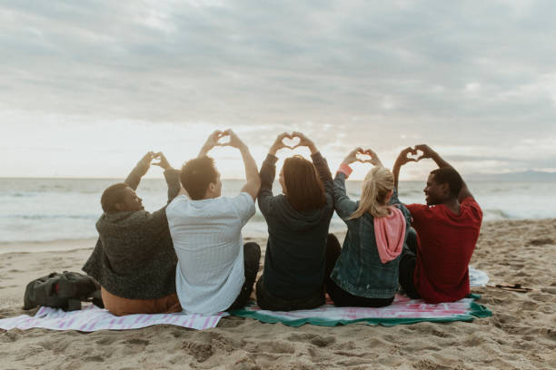 istock Friends making love heart hands at the beach 2158213690