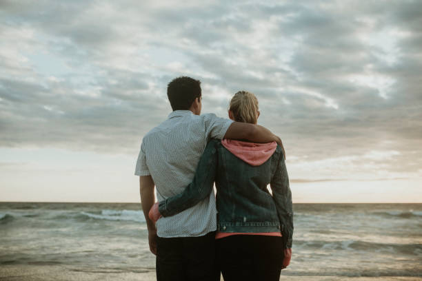 istock Young couple hugging at the beach 2158213734