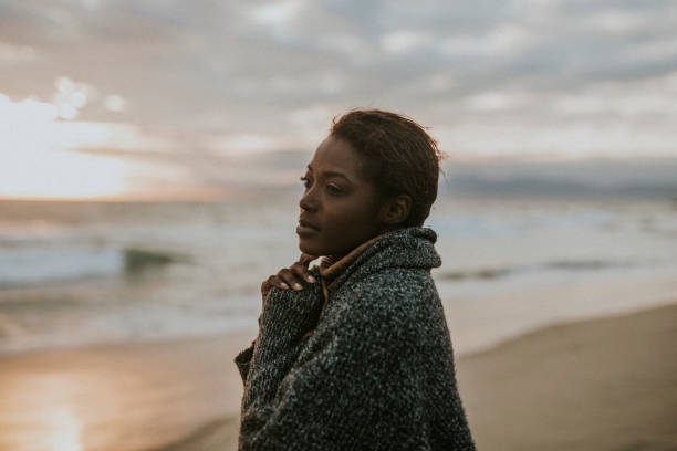 istock Black woman on the beach at sunset 2158213735