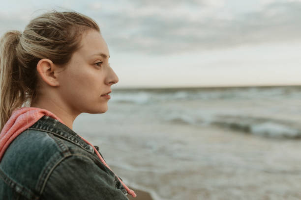 istock Woman on a gloomy beach 2158213763