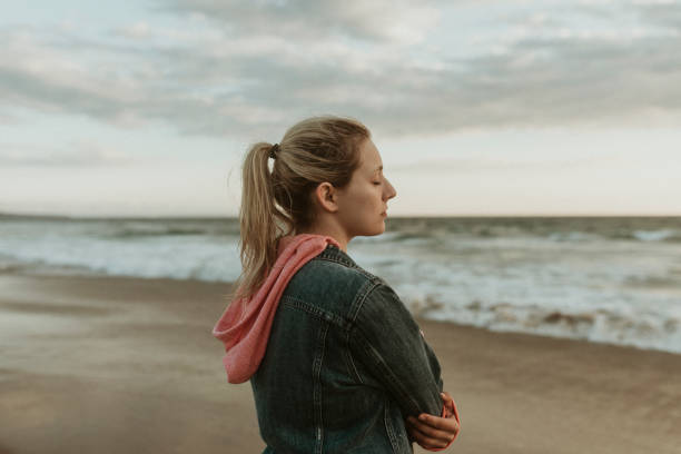 istock Woman on a gloomy beach 2158213780