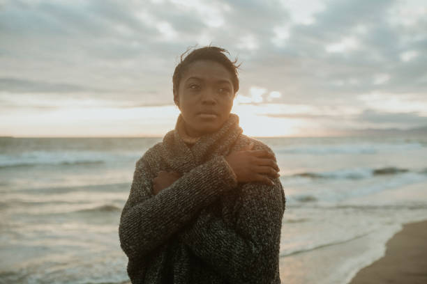 istock Black woman on the beach at sunset 2158213781