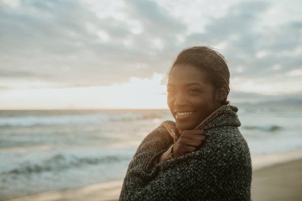 istock Cheerful woman on the beach on a cold summer night 2158213786