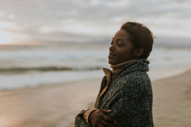 istock Black woman on the beach at sunset 2158213822