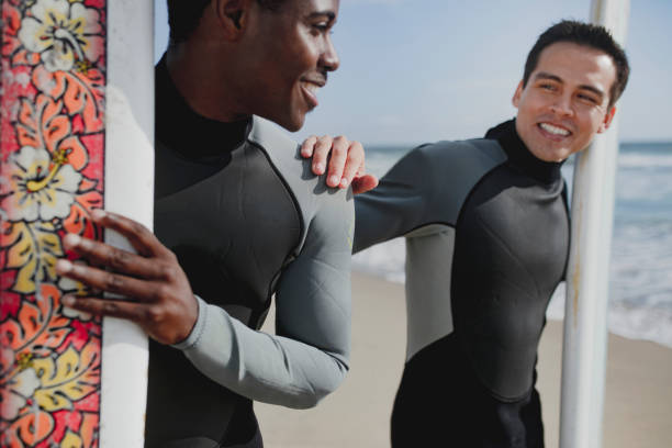 istock Happy surfers at the beach 2158214476