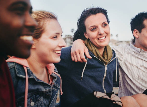 istock Cheerful friends hugging on the beach 2158214514
