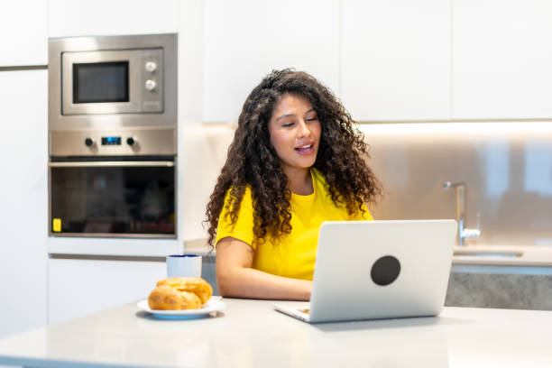 istock Freelancer having breakfast while attending online meeting from home 2158215053