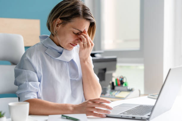 istock Stressed office worker suffering from a headache at work. Emotions at work concept 2158215173