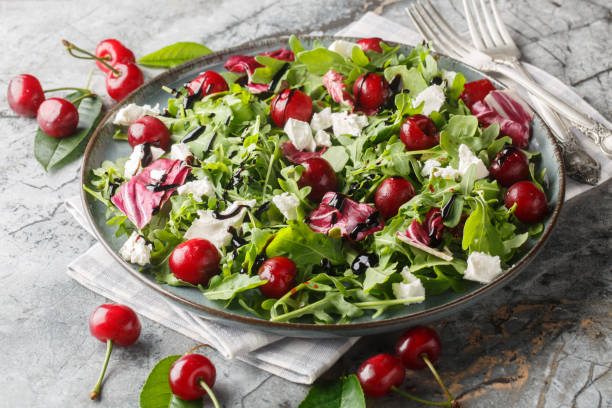 istock Spicy Cherry salad with arugula, radicchio and feta cheese dressed with balsamic dressing close-up in a plate. Horizontal 2158215910