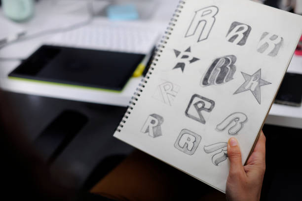 istock Hand Holding Notebook With Drew Brand Logo Creative Design Ideas 2158215931