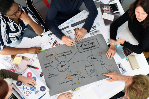 istock Group of diverse people brainstorming together 2158217573