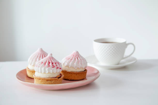 istock cupcakes with cup of coffee on white table 2158220698