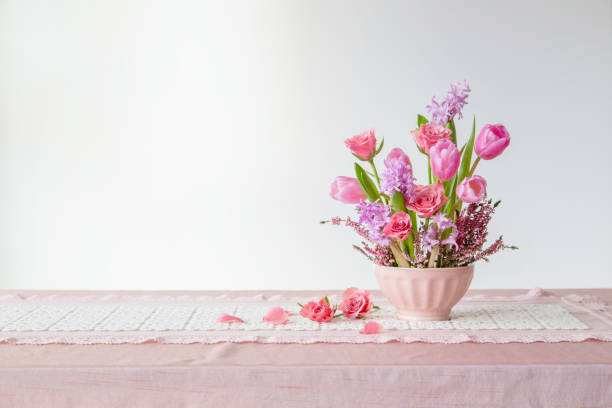 istock pink flowers in vase on background white wall 2158220699