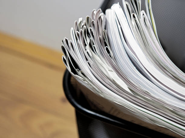 Newspapers and magazines in the wastepaper basket