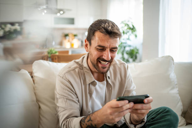 istock A young man spends time playing smatphone games in his new home 2158222190