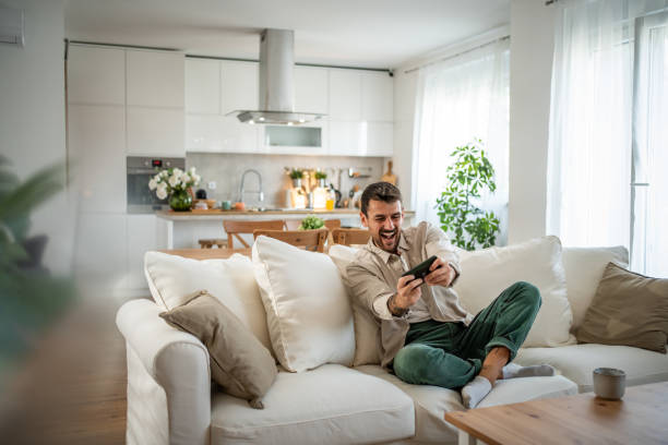 istock A young man spends time playing smatphone games in his new home 2158222252
