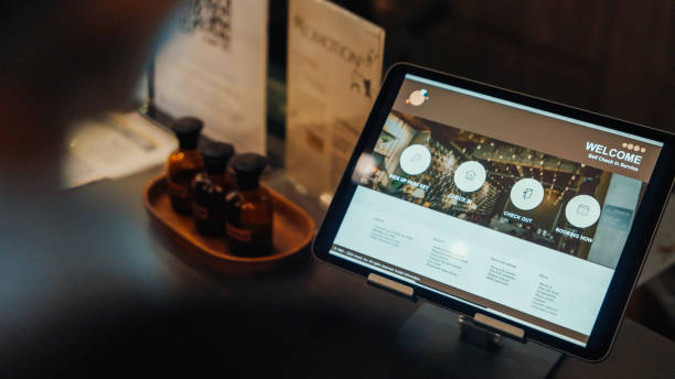 istock Over the shoulder Self Check-In Success on Tablet at Hostel 2158222903