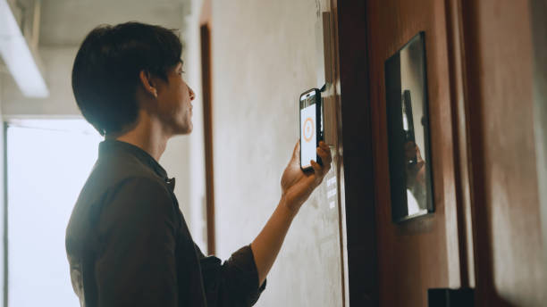 Hostel staff using smart phone unlock a hostel door room