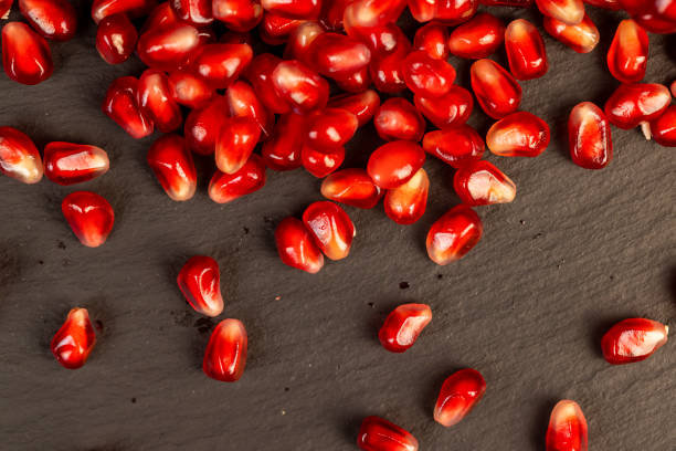 Red ripe pomegranate on the table, sweet red pomegranate close-up