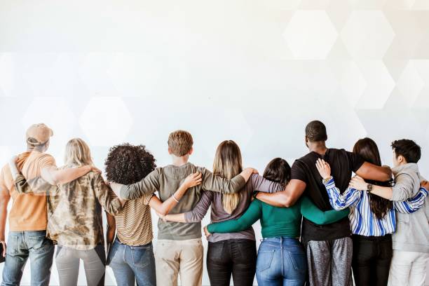 istock Rearview of diverse people hugging each other 2158225937