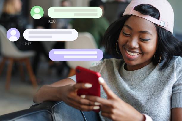 istock Cheerful black woman texting to her friend 2158226014