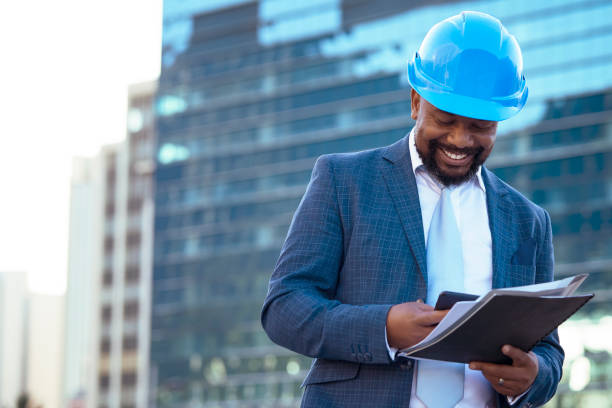 istock Businessman looking at his new building plan 2158226971