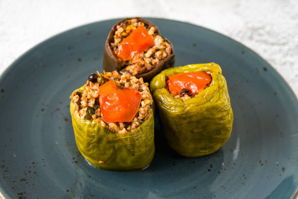 istock Stuffed green bell pepper and eggplant with olive oil on stone table 2158228450