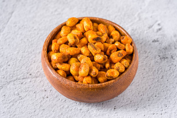 istock Roasted corn nuts with sauce in wooden bowl on white stone table 2158229014
