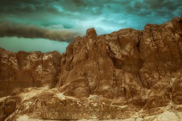 A scenic view of a rocky, rugged landscape with a dramatic sky above it