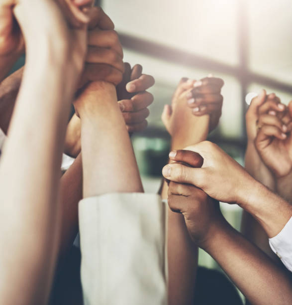 istock Business people, holding hands and group solidarity with support for team building, help or collaboration. Partnership, fingers and corporate trust for staff union or colleagues, goal or agreement 2158230096