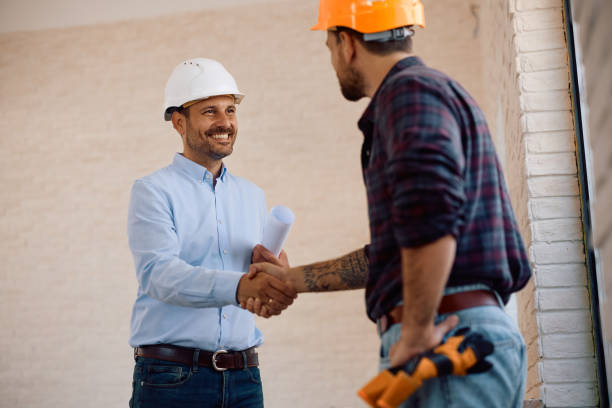 istock Happy building contractor shaking hands with a worker at construction site. 2158230556