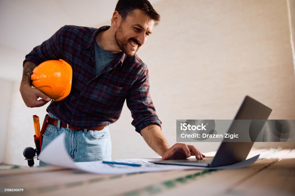 Construction Working At Computer Happy Worker Using Laptop At Construction Site Stock Photo - Download ...