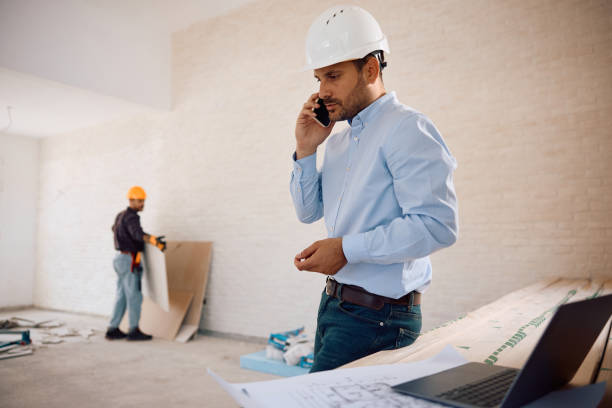 istock Male architect communicating on mobile phone at construction site. 2158230584