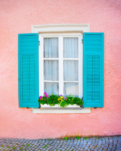 istock open window with green wooden shutters, pink texture wall 2158231106