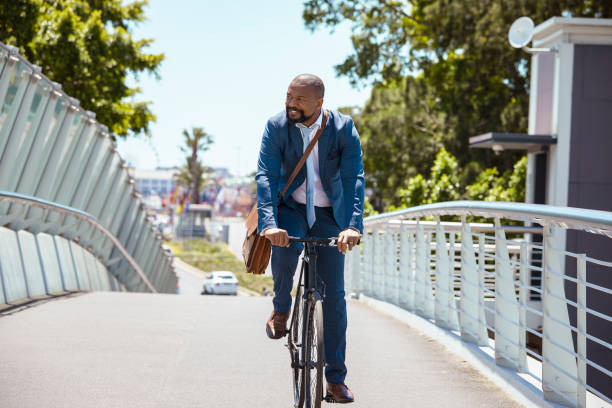 istock Man cycling to work on a beautiful summer day 2158233832