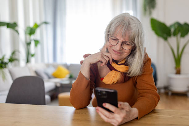 istock Senior Woman Embracing Technology at Home 2158233878